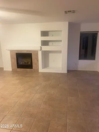 a view of an empty room and fire place