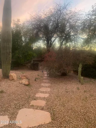a view of a pathway with a wrought fence