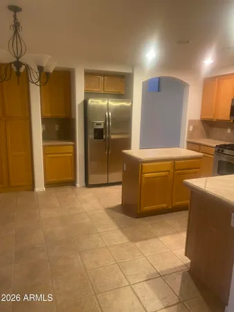a kitchen with stainless steel appliances a refrigerator and a stove