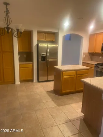 a kitchen with stainless steel appliances a refrigerator and a stove