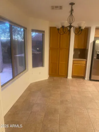 a view of a hallway with wooden floor and glass doors