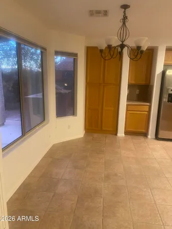 a view of a hallway with wooden floor and glass doors