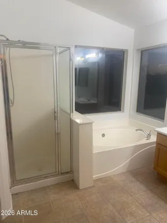 a bathroom with a bathtub and a shower