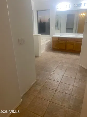a bathroom with a large mirror and a shower
