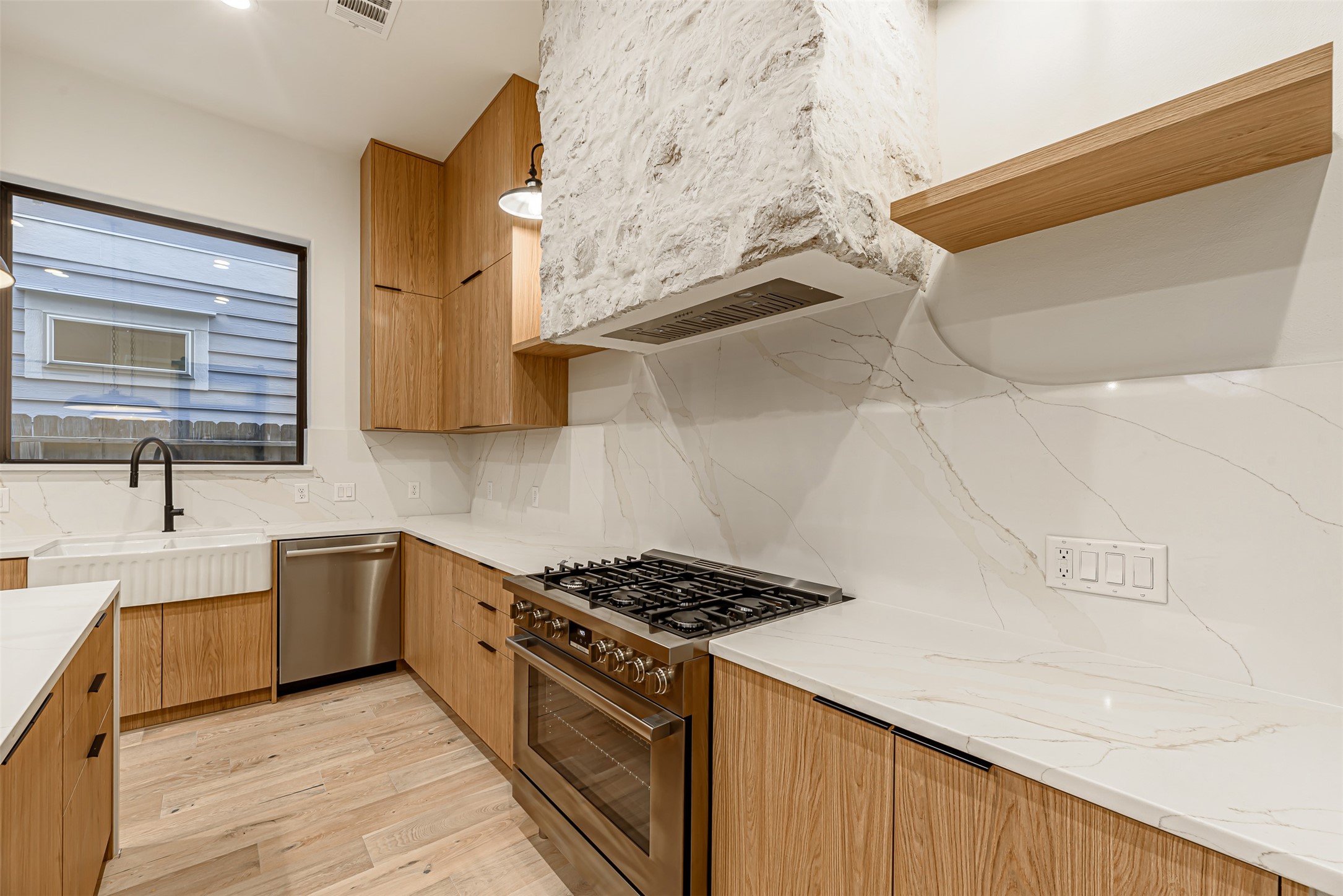 1104 West 9th Street Houston, TX 77007 - Photo 8 of 25 a kitchen with stainless steel appliances a stove a sink and a microwave