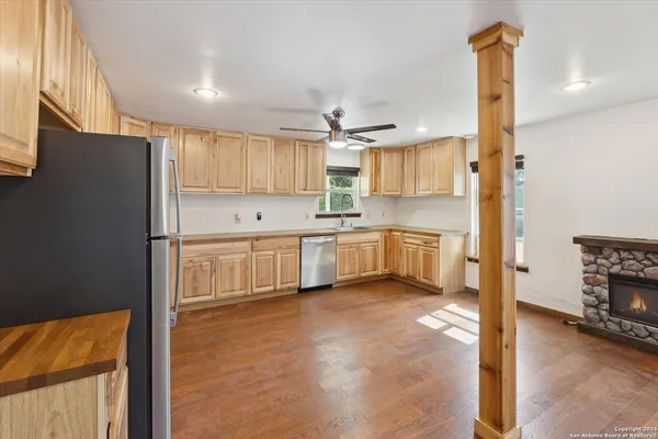 a kitchen with stainless steel appliances granite countertop a refrigerator and a stove top oven