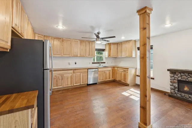 a kitchen with stainless steel appliances granite countertop a refrigerator and a stove top oven