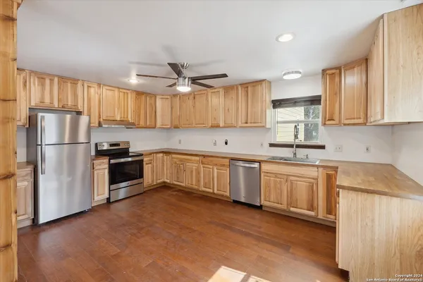 a kitchen with sink and cabinets