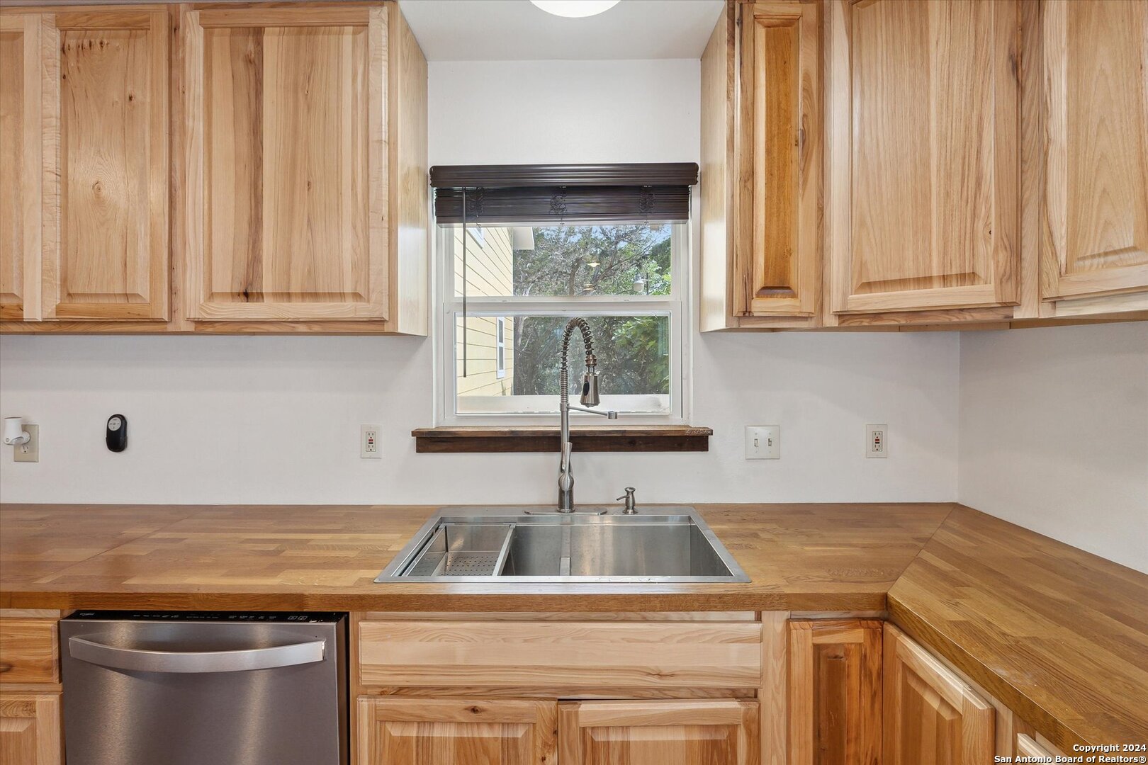 497 Black Bass Road Lakehills, TX 78063 - Photo 21 of 54 a kitchen with a sink cabinets and window