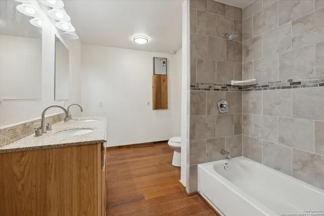 a bathroom with a granite countertop sink a mirror and vanity