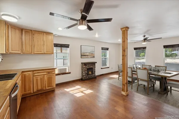 a kitchen with sink cabinets and wooden floor