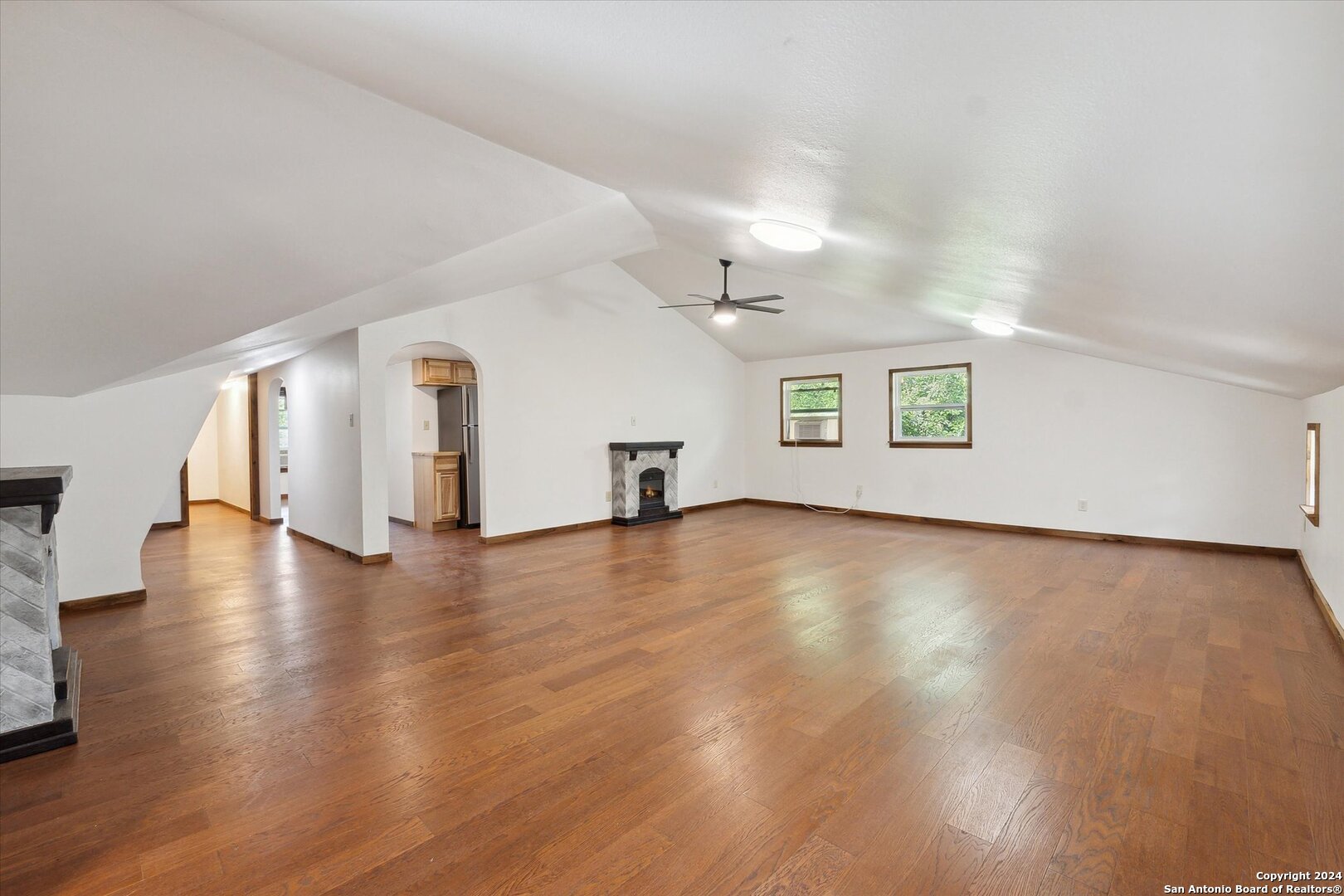 497 Black Bass Road Lakehills, TX 78063 - Photo 32 of 54 a view of a livingroom with wooden floor and a window