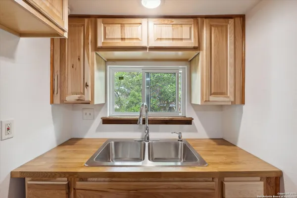 a bathroom with a sink and a window