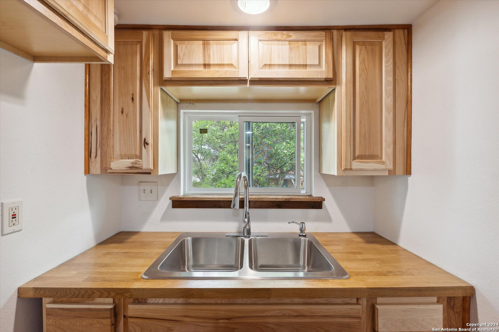 497 Black Bass Road Lakehills, TX 78063 - Photo 35 of 54 a kitchen with sink and window