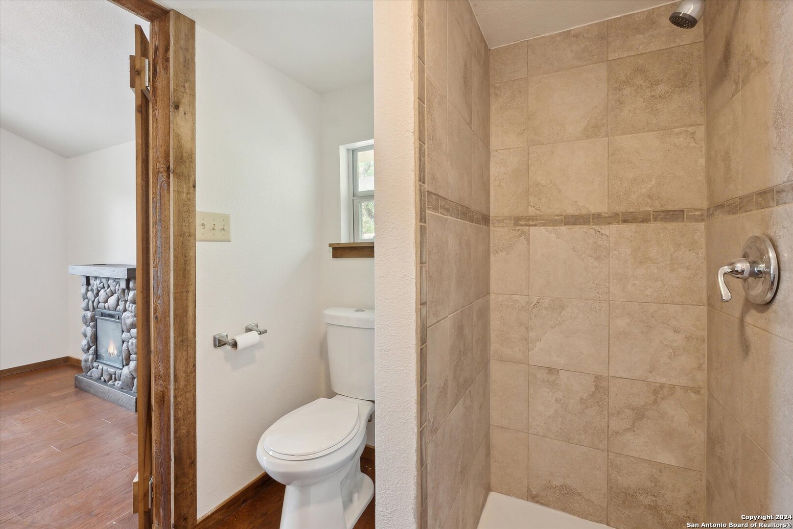 497 Black Bass Road Lakehills, TX 78063 - Photo 39 of 54 a bathroom with a toilet and a shower