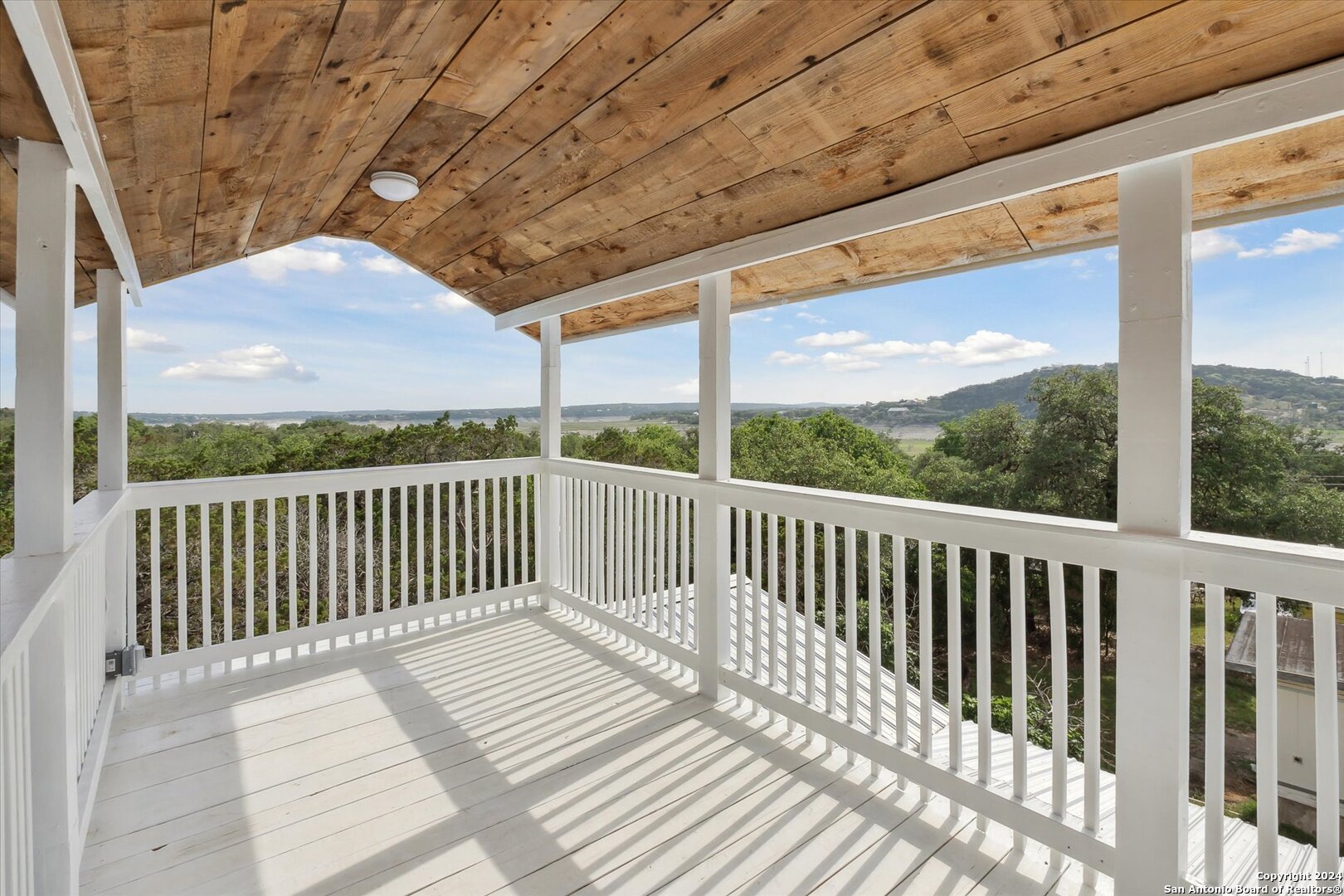 497 Black Bass Road Lakehills, TX 78063 - Photo 40 of 54 a view of balcony with wooden floor