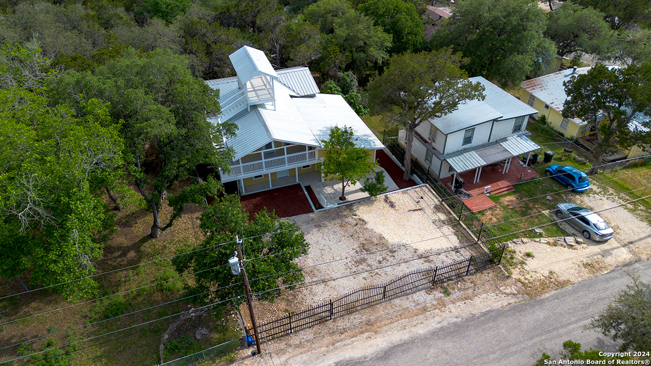 497 Black Bass Road Lakehills, TX 78063 - Photo 44 of 54 an aerial view of a house with a yard and garden