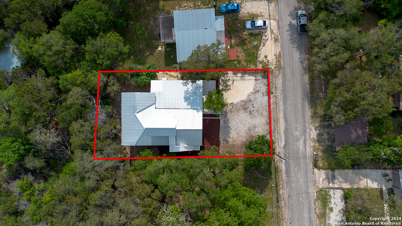 497 Black Bass Road Lakehills, TX 78063 - Photo 45 of 54 an aerial view of a house with a yard and fountain