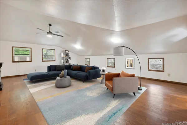 a living room with furniture and wooden floor