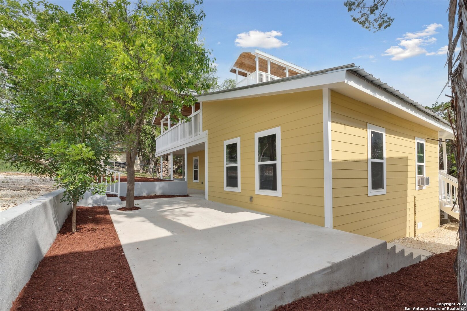 497 Black Bass Road Lakehills, TX 78063 - Photo 7 of 54 a view of a house with a patio