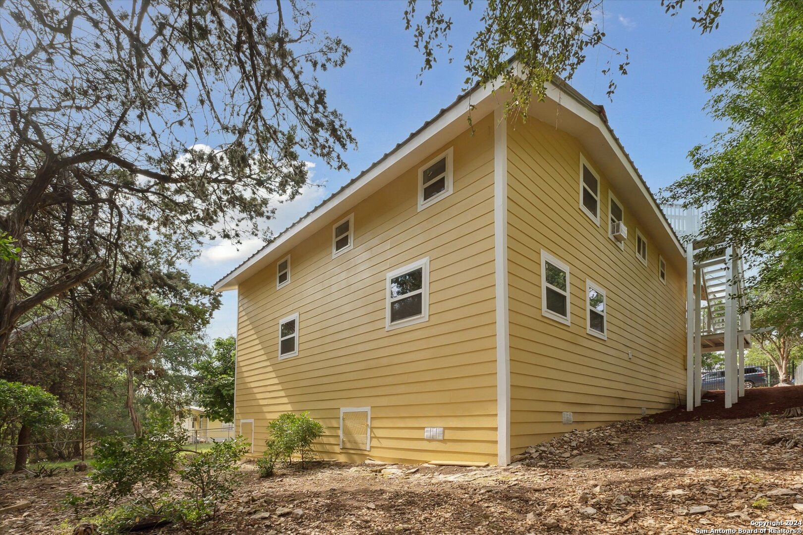 497 Black Bass Road Lakehills, TX 78063 - Photo 9 of 54 a view of a house with a yard
