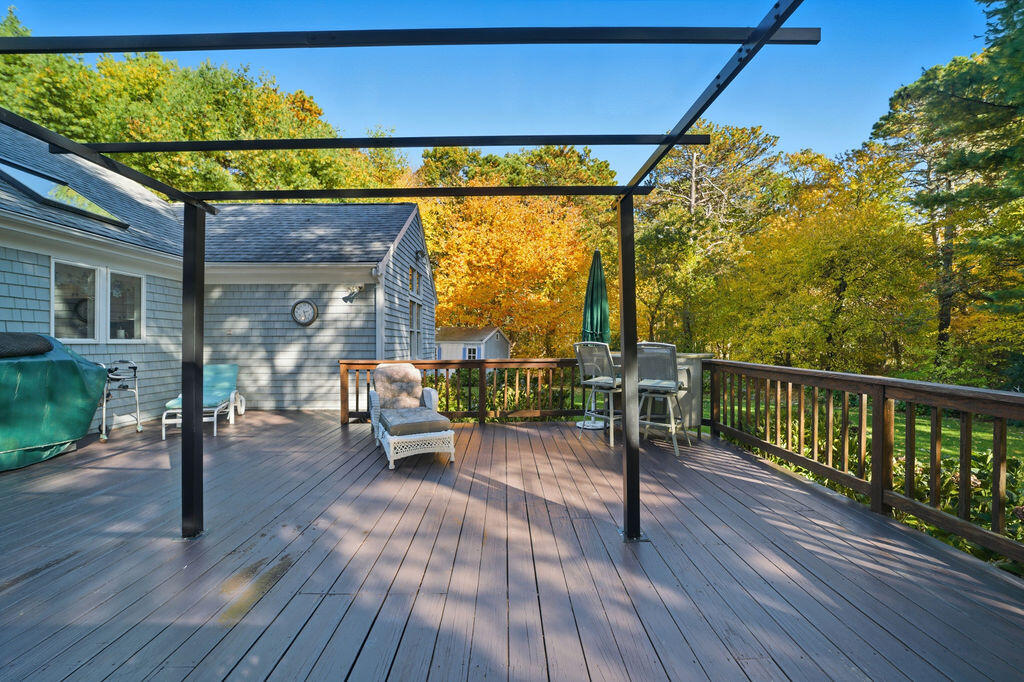 139 Falling Leaf Lane Osterville, MA 02655 - Photo 13 of 40 a view of a chairs and table in patio with wooden fence