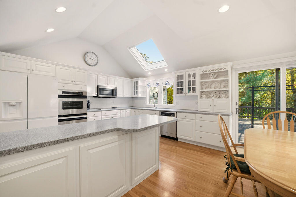 139 Falling Leaf Lane Osterville, MA 02655 - Photo 16 of 40 a kitchen with white cabinets and appliances