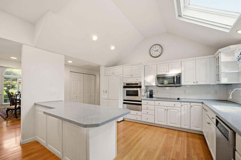 139 Falling Leaf Lane Osterville, MA 02655 - Photo 17 of 40 a kitchen with stainless steel appliances a stove sink microwave and cabinets