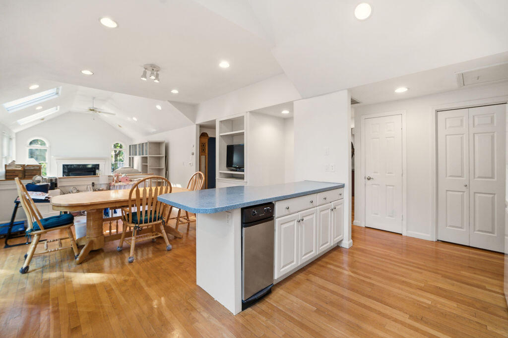 139 Falling Leaf Lane Osterville, MA 02655 - Photo 18 of 40 a kitchen with stainless steel appliances granite countertop a table chairs sink and wooden floor