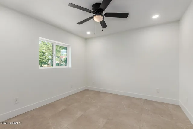 an empty room with a ceiling fan