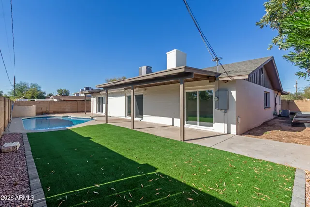 a view of a backyard with wooden fence