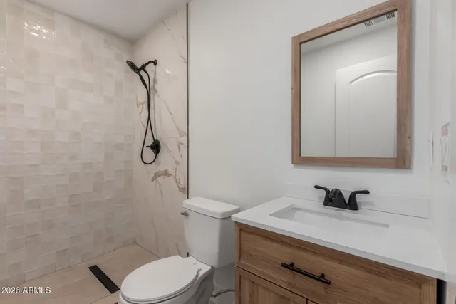 a bathroom with a sink toilet and shower