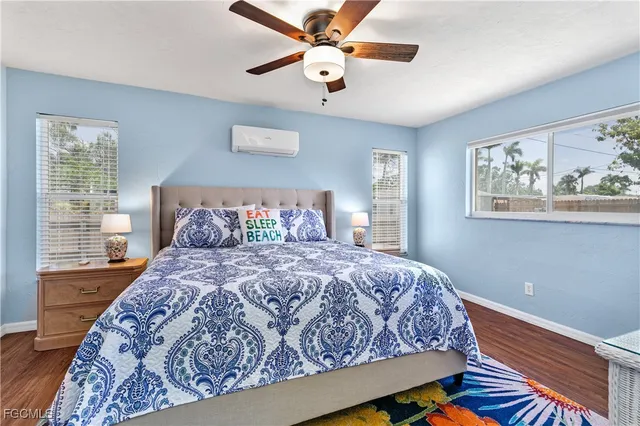 a bedroom with bed and wooden floor