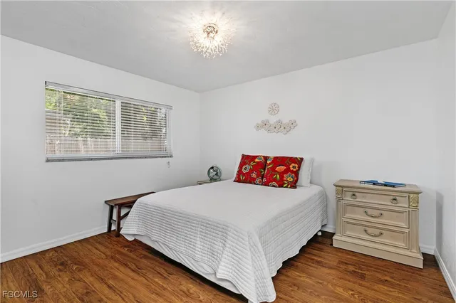 a bedroom with a bed dresser and a window