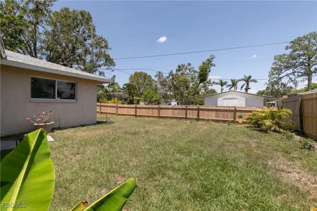 a view of backyard with seating area and trees