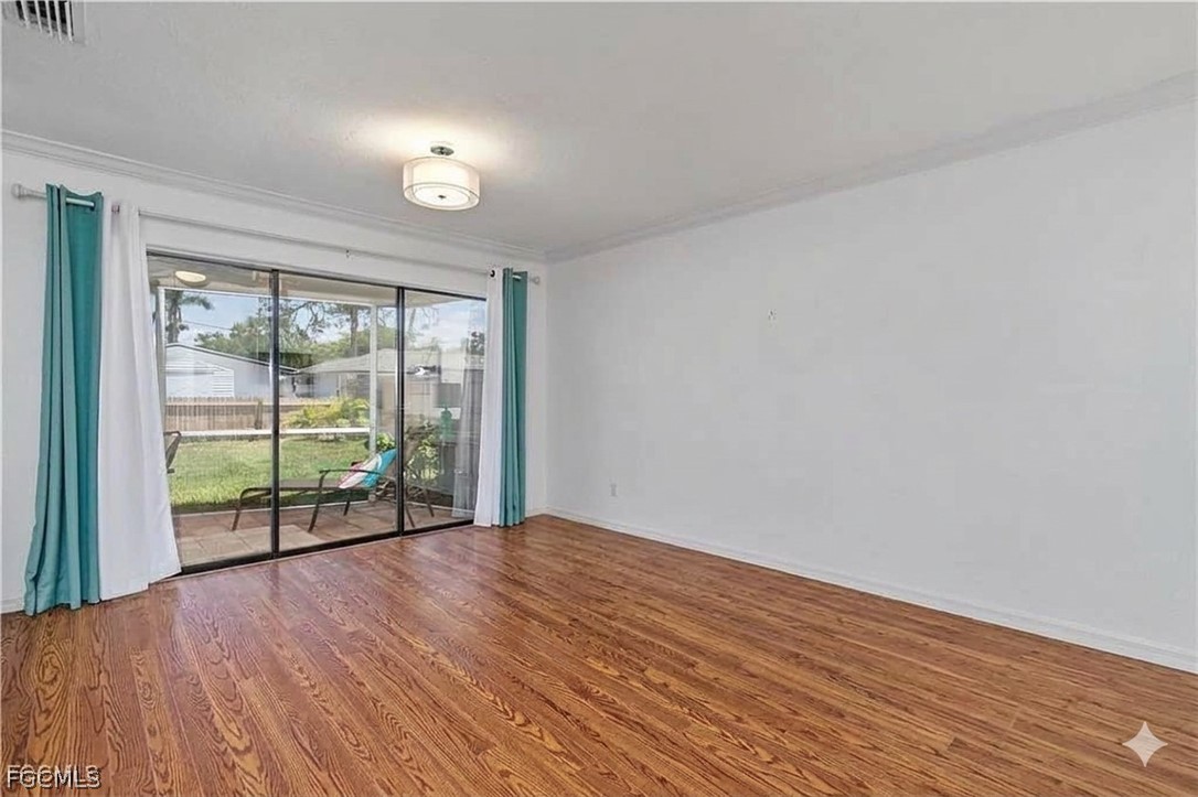 3717 Hanover Street Fort Myers, FL 33901 - Photo 7 of 41 a view of an empty room with wooden floor and a window