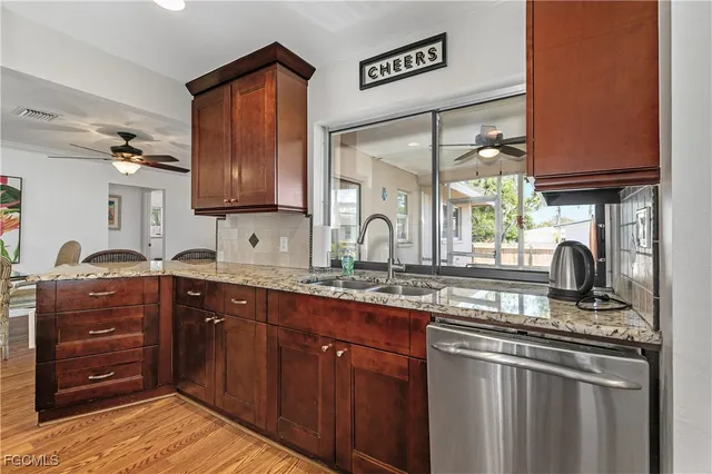 a kitchen with stainless steel appliances granite countertop a sink stove and refrigerator