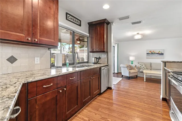a large kitchen with granite countertop lots of counter top space and a sink