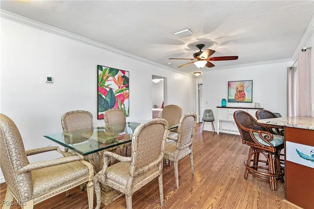 a view of a dining room with furniture and wooden floor
