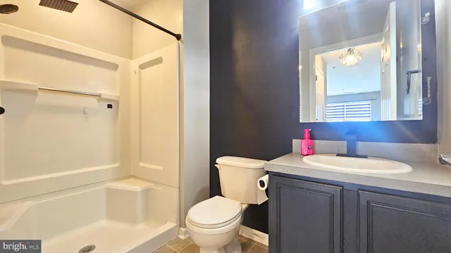 a bathroom with a sink toilet vanity and shower