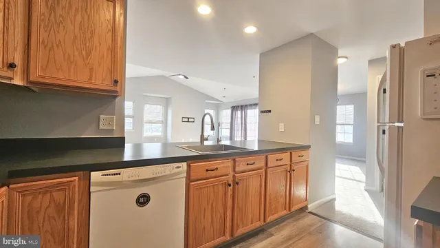 a kitchen with stainless steel appliances granite countertop a refrigerator and a stove