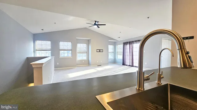 a open kitchen with stainless steel appliances granite countertop a stove top oven a sink with granite countertops and cabinets