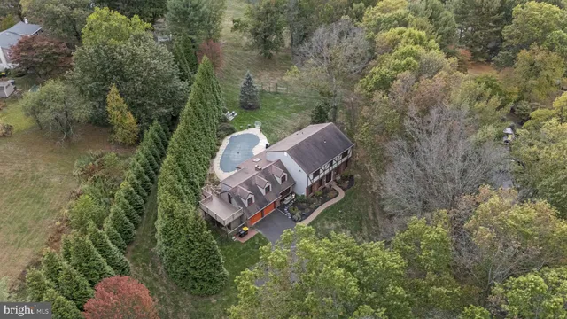 a view of a house with a backyard and trees
