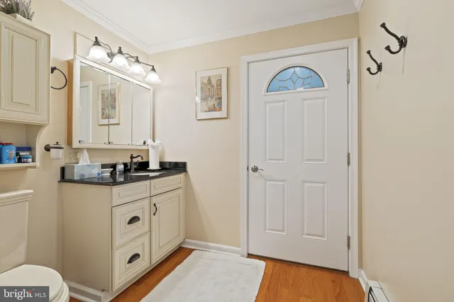 a bathroom with a sink a mirror and a toilet