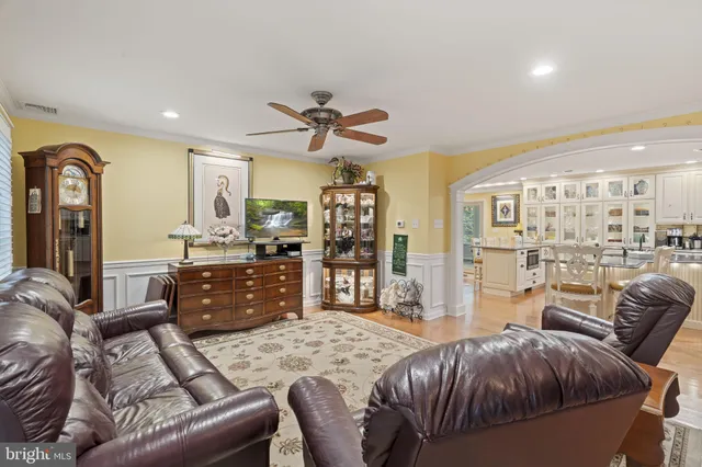 a living room with furniture and a kitchen view