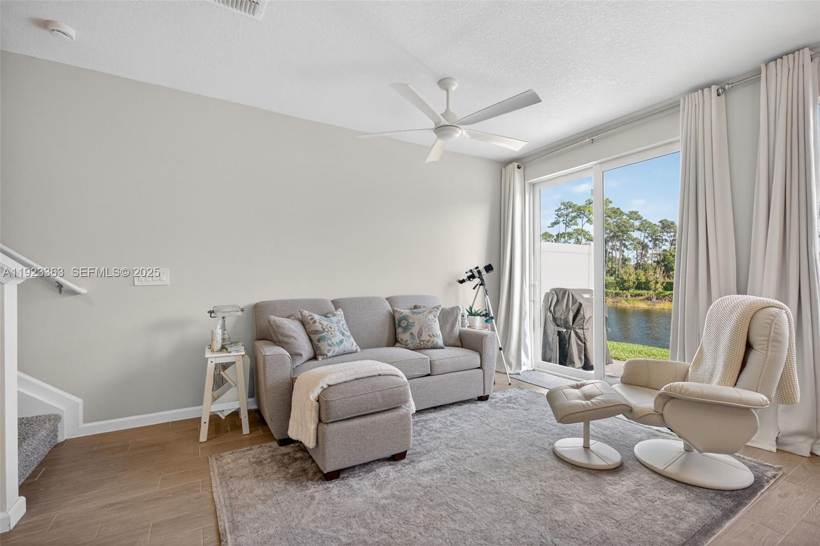 5746 Southeast Edgewater Circle Stuart, FL 34997 - Photo 12 of 38 a living room with furniture and a large window