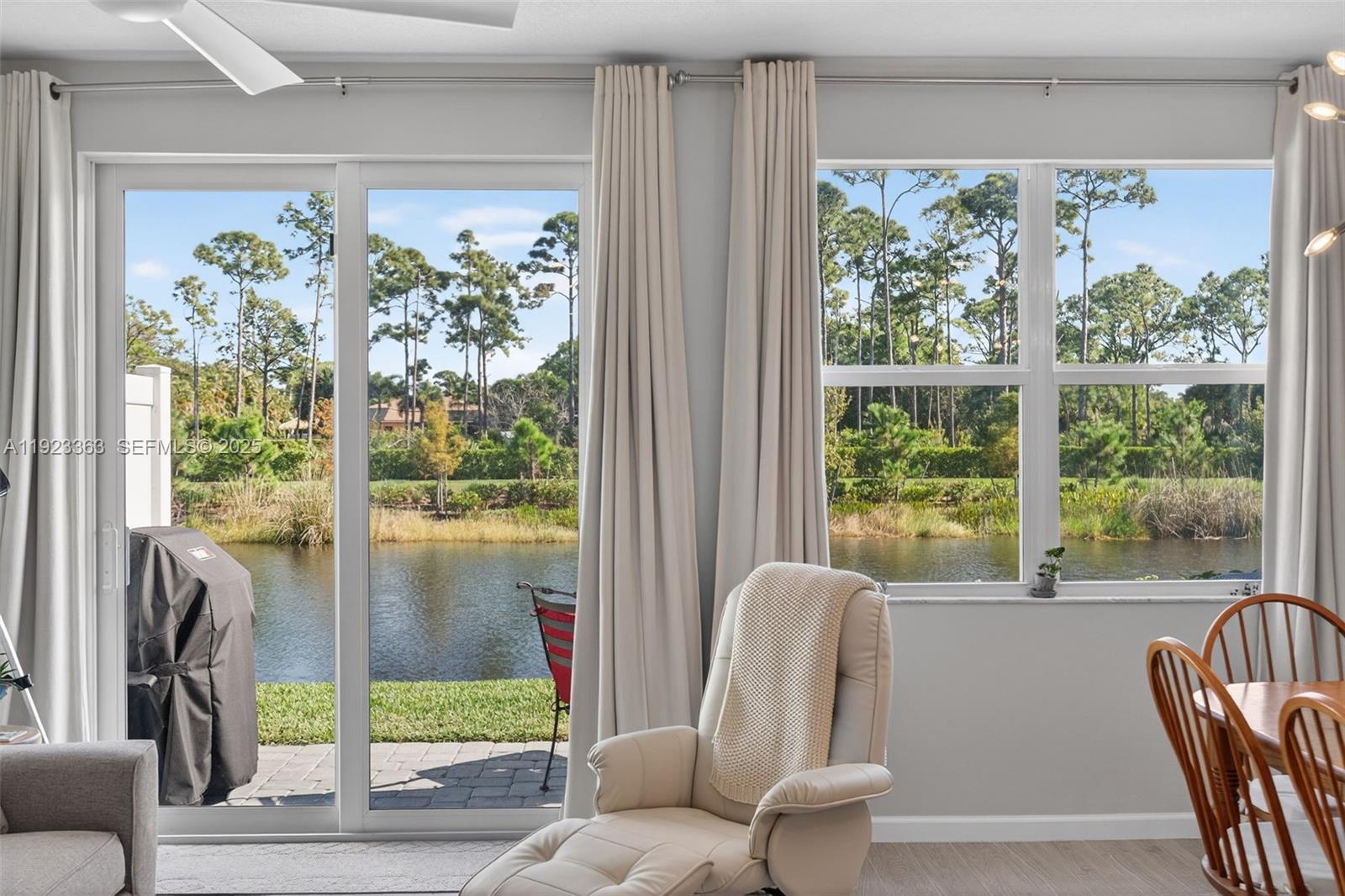 5746 Southeast Edgewater Circle Stuart, FL 34997 - Photo 15 of 38 a living room with furniture and a large window