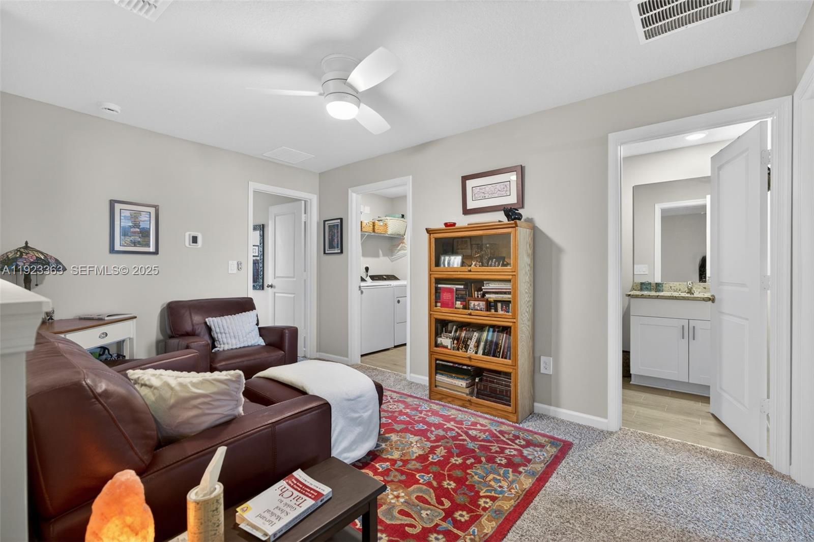 5746 Southeast Edgewater Circle Stuart, FL 34997 - Photo 16 of 38 a living room with furniture and a book shelf