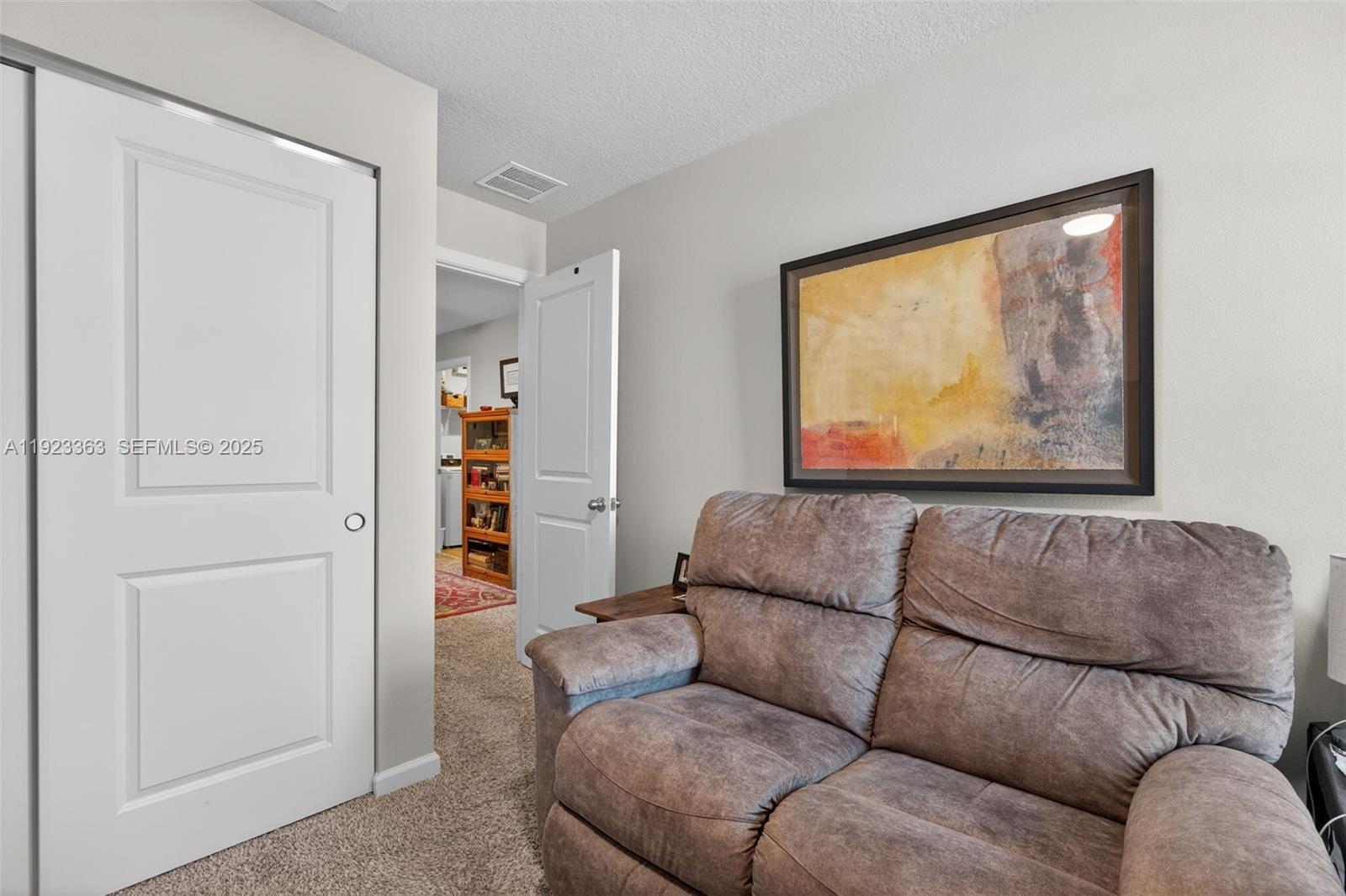 5746 Southeast Edgewater Circle Stuart, FL 34997 - Photo 18 of 38 a living room with furniture and a window