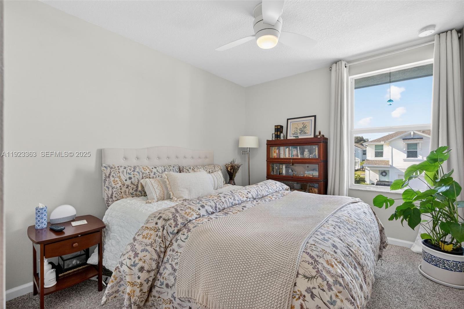 5746 Southeast Edgewater Circle Stuart, FL 34997 - Photo 19 of 38 a bed room with a bed and a chair in it